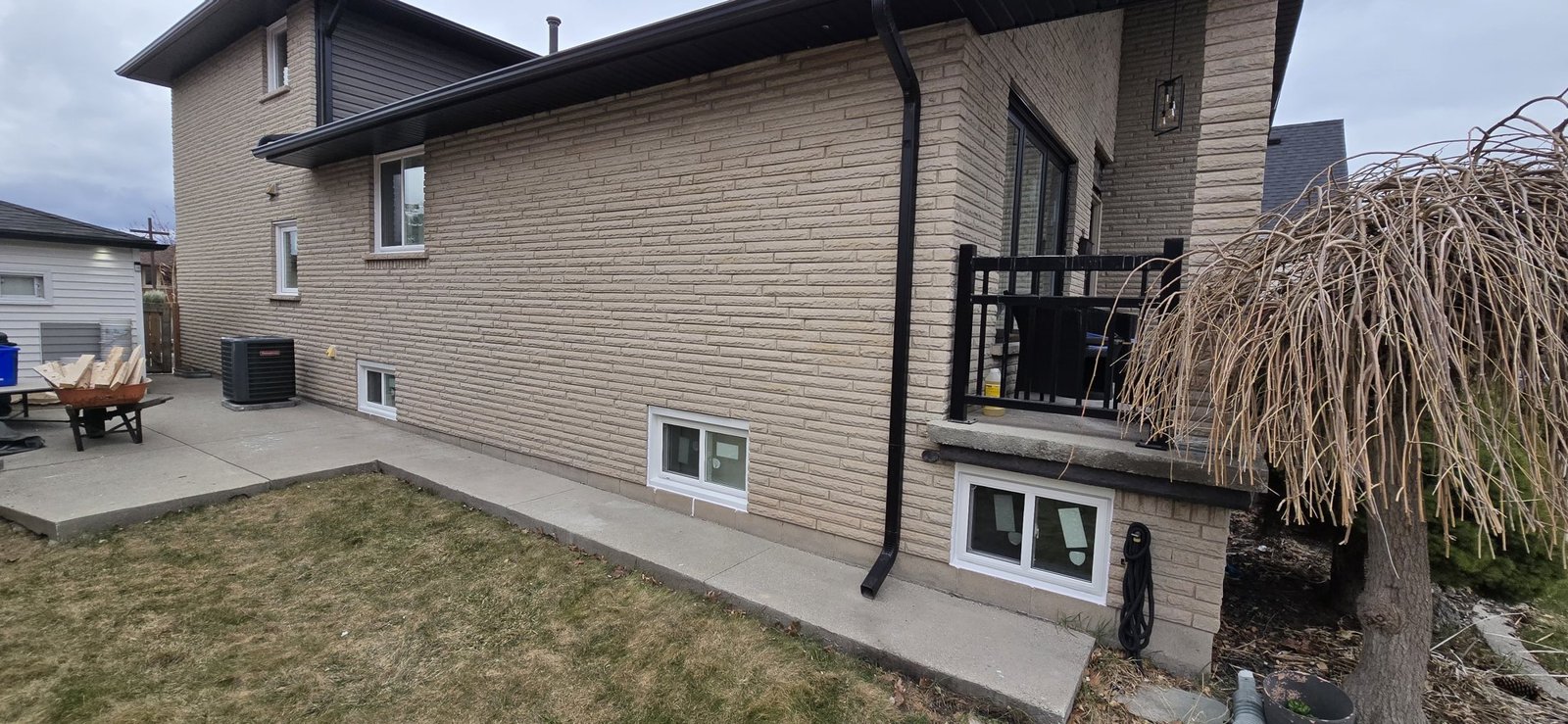 Side elevation of a Hamilton-area brick home showing windows at several levels