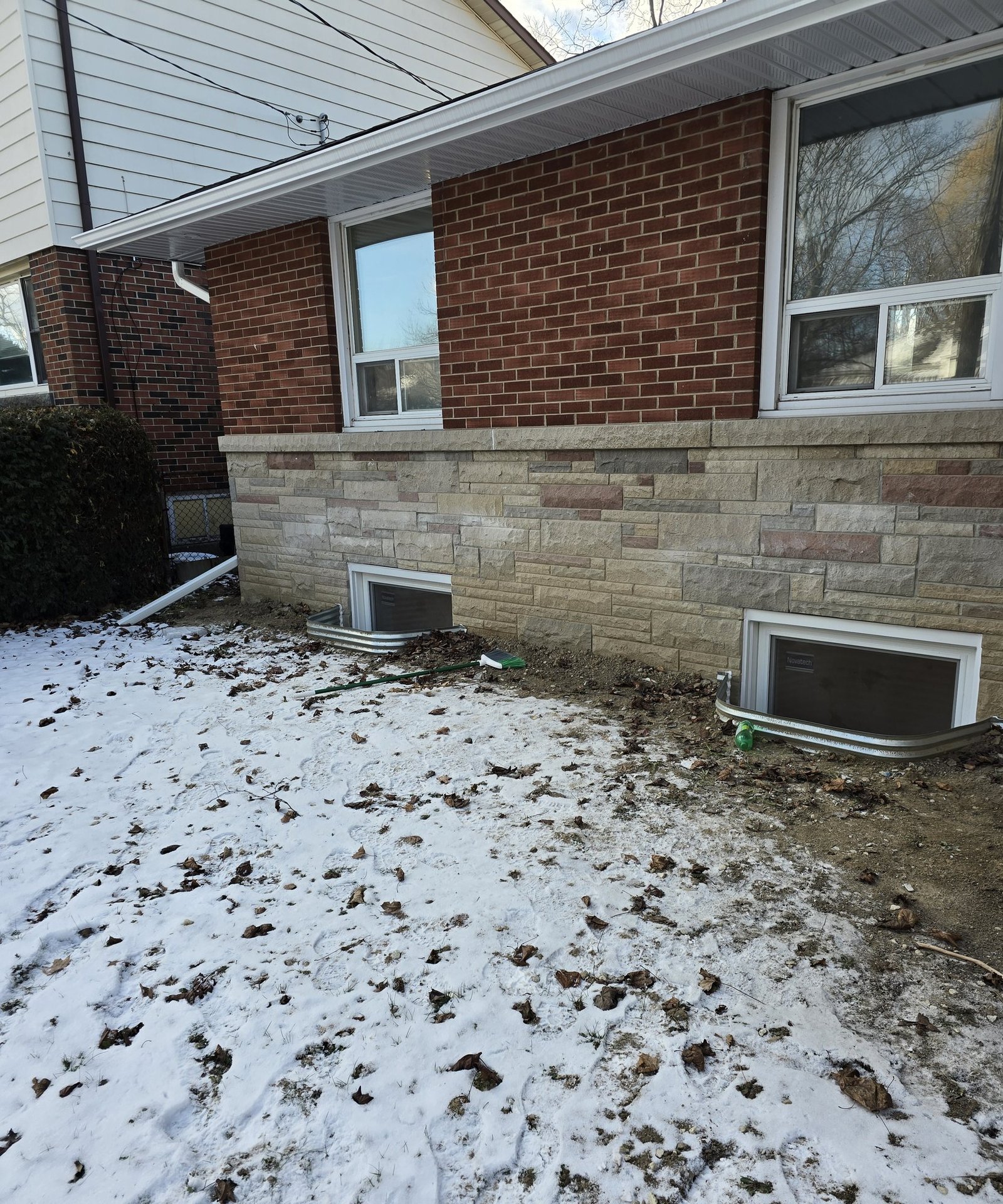 Two enlarged basement egress windows and new wells on a Hamilton Mountain home
