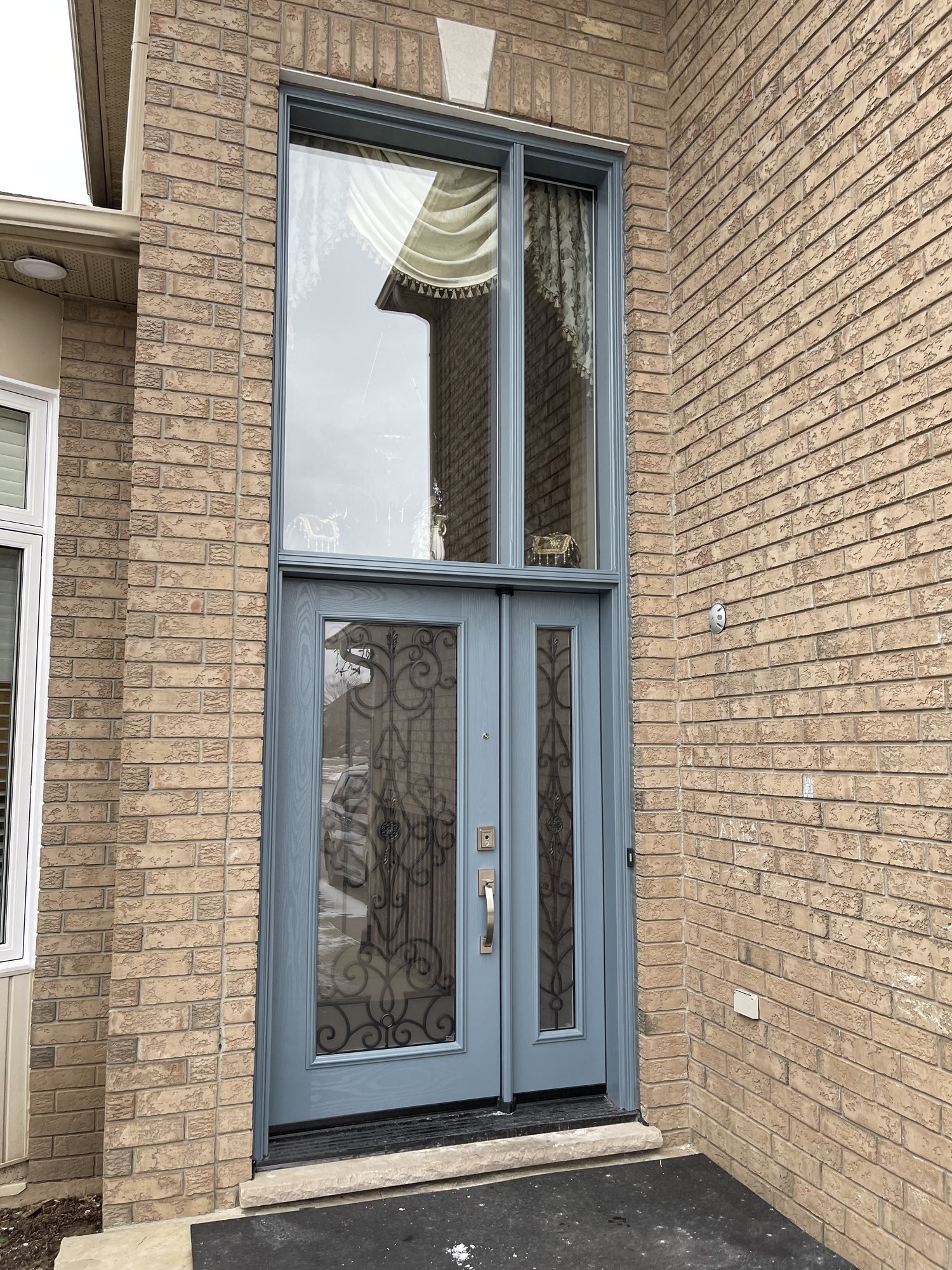 Slate-blue front entrance with decorative glass, opening sidelight and transom in Stoney Creek