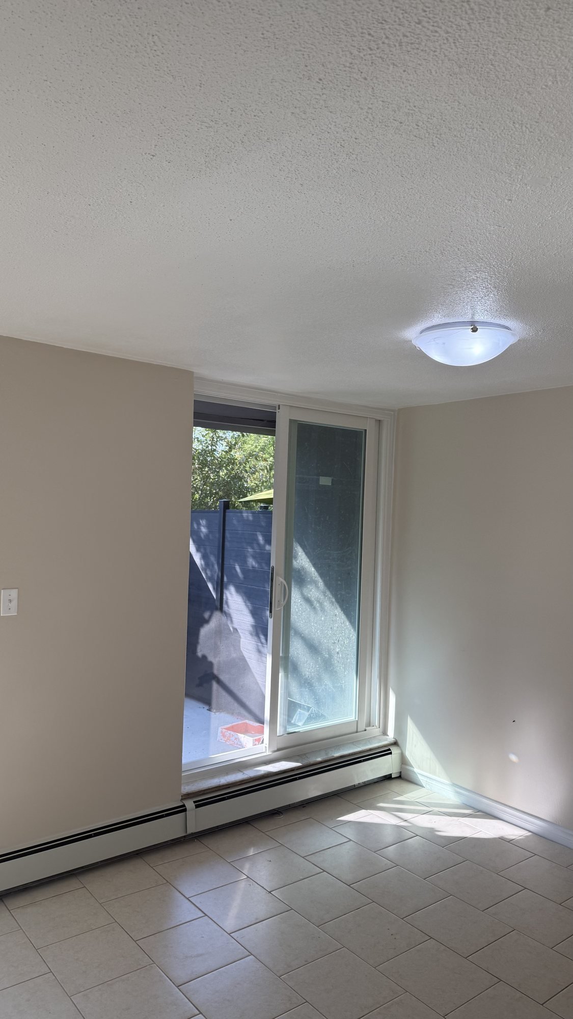 New white sliding patio door opening to a high-rise balcony in Stoney Creek